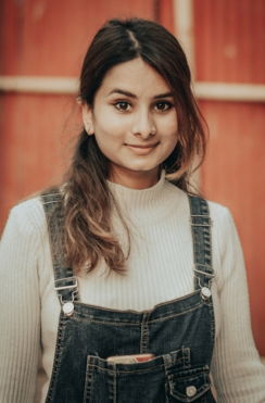 woman in white long sleeve shirt and blue denim dungaree
